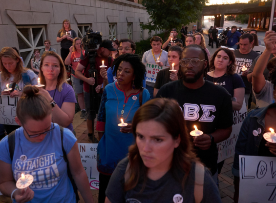 People with candles at a vigil