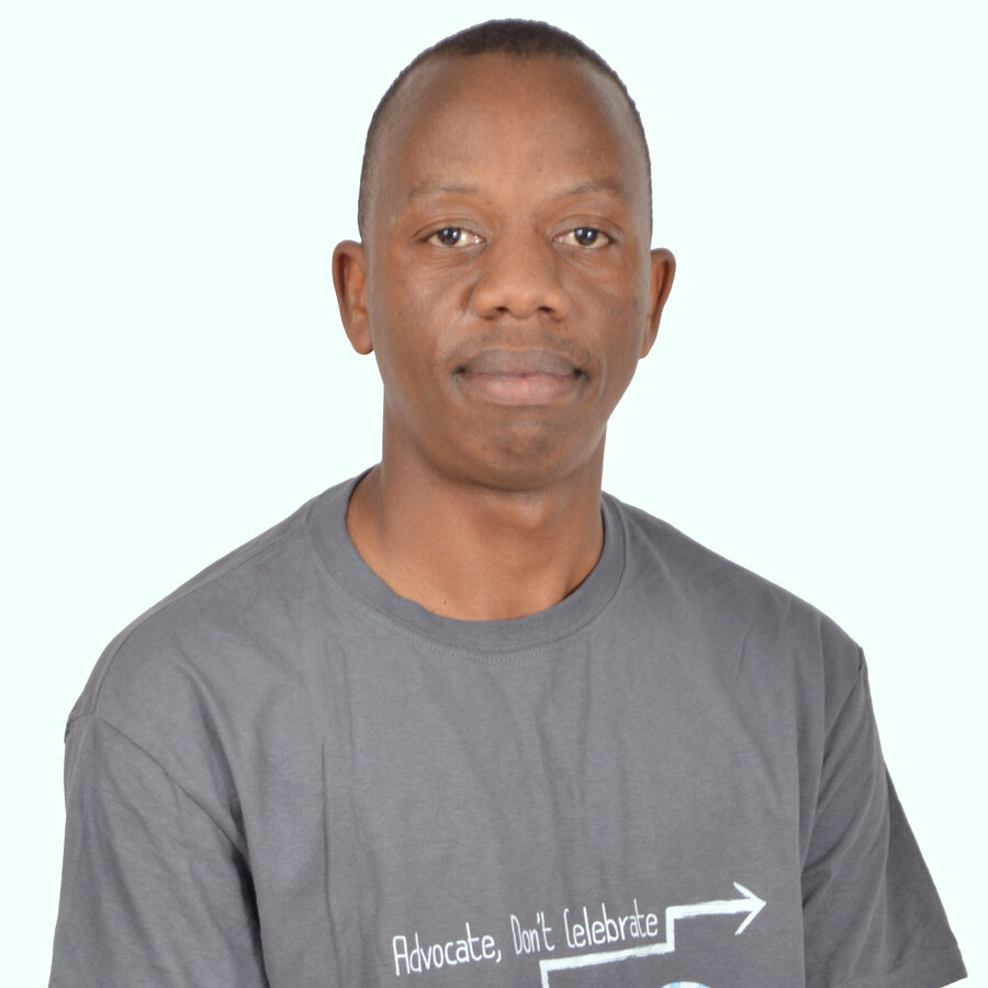 Tinotenda Dzikiti, wearing a T1International “Advocate, Don’t Celebrate” T-shirt