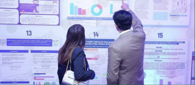 Maham looking at a poster at the Pakistan Endocrinology Conference with someone else