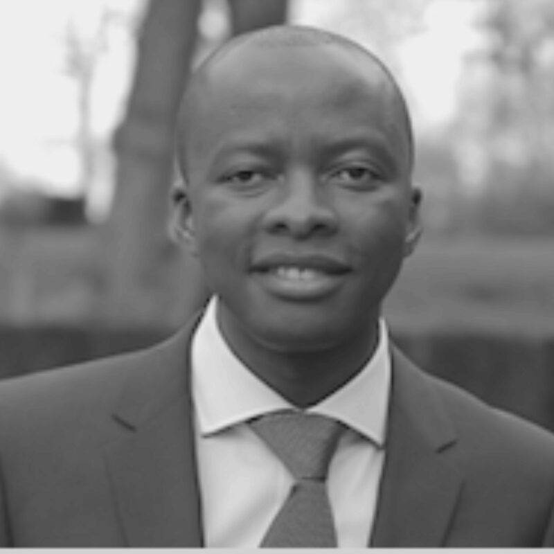 Black and white portrait of Justin Cikomola.