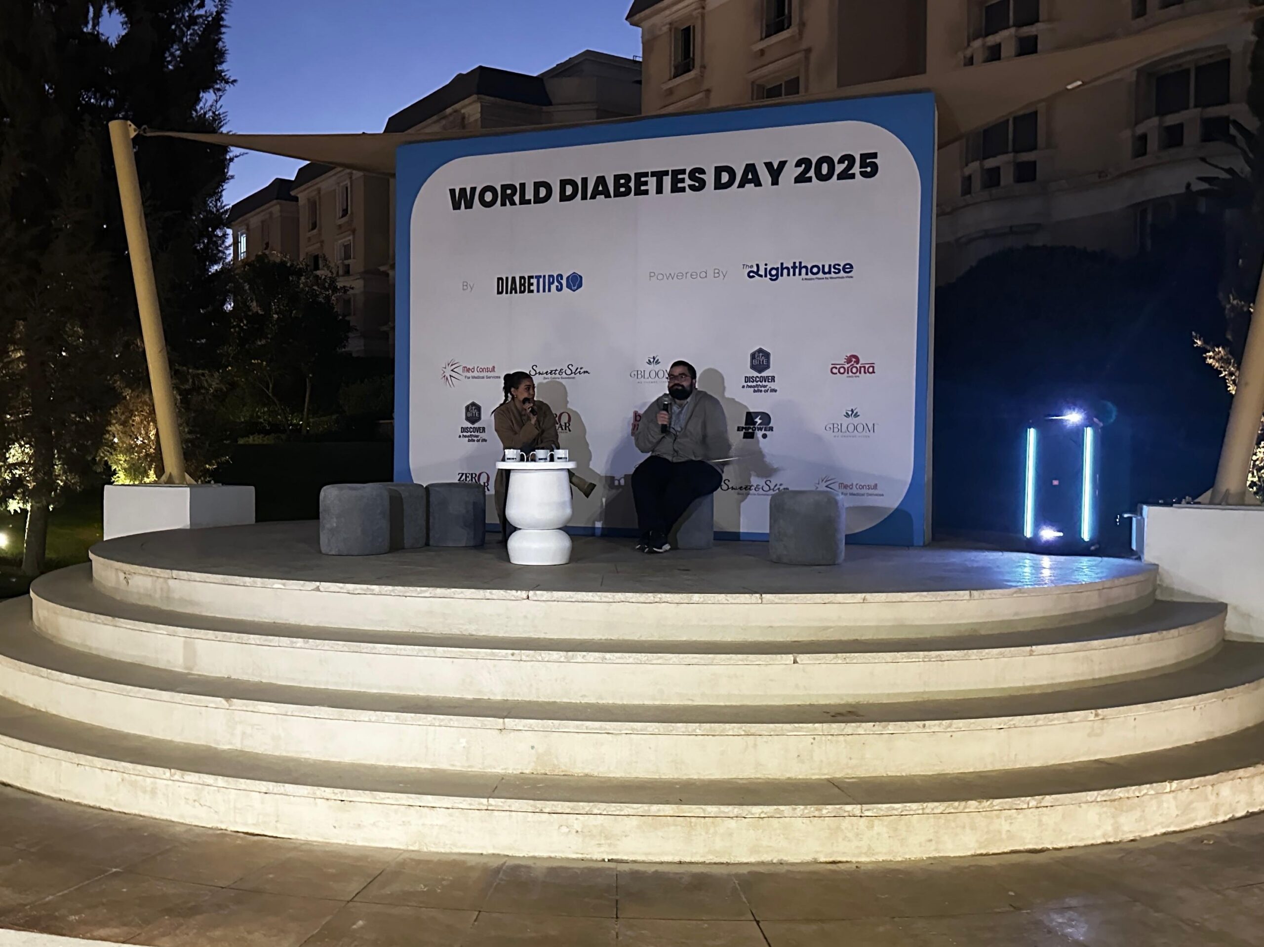 Ali speaking with an interviewer at a World Diabetes Day event