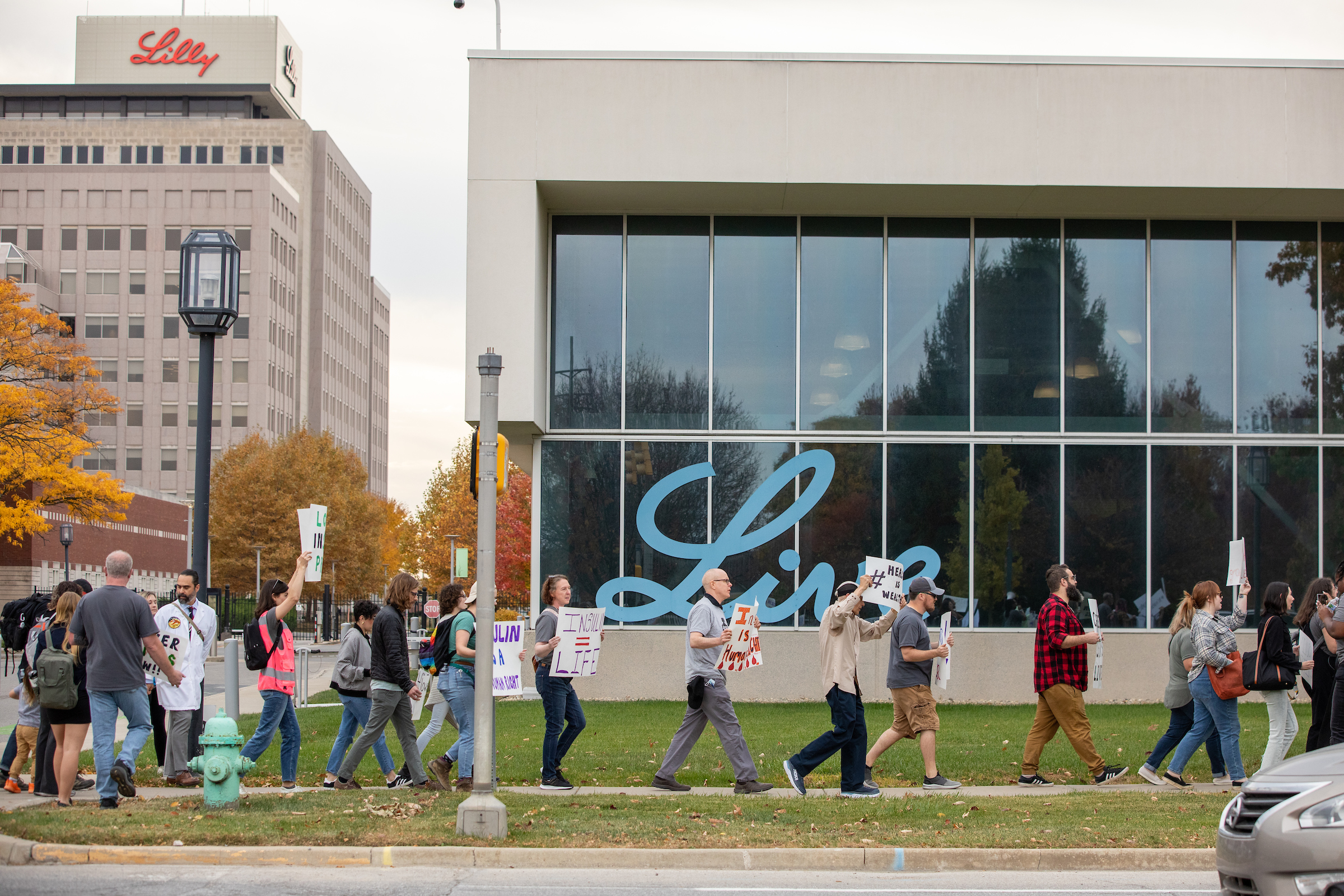 Group of people marching past a Lily building
