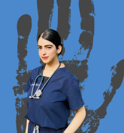 Maham, a woman in scrubs, faces the camera in front of a graphic of a grey hand on a blue background