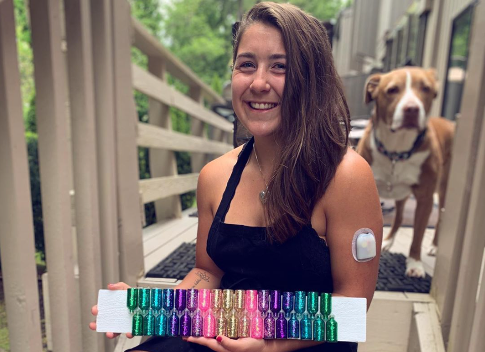 Advocate holding vials in all colors for art project. Dog in background!