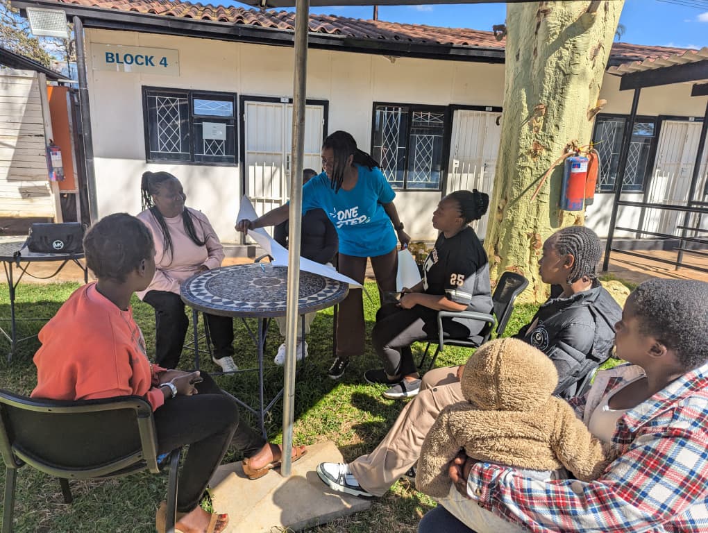 people sitting around table at Zimbabwe event in 2026