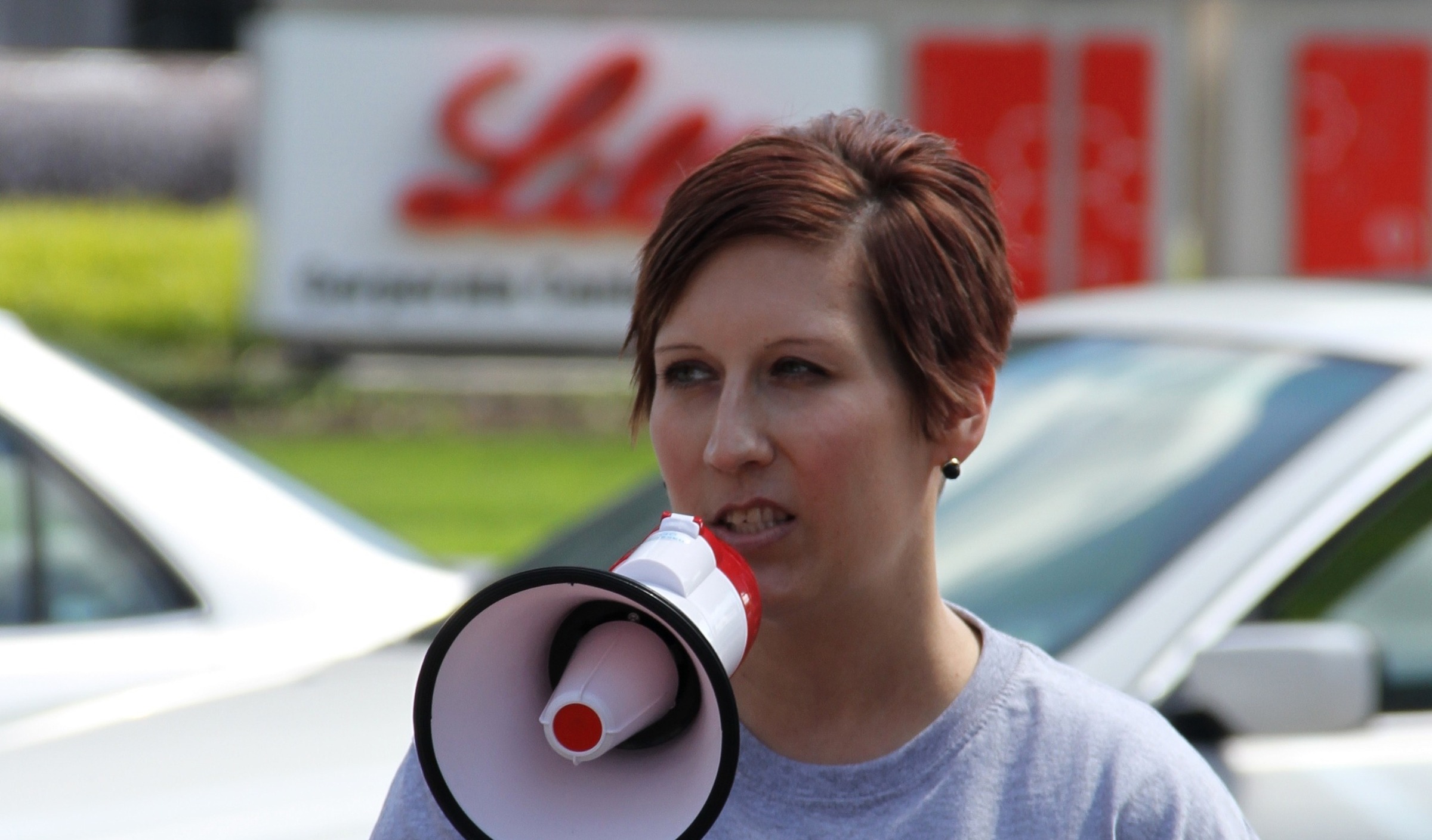 Angela outside Eli Lilly speaking into a megaphone