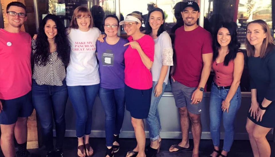 Arizona Chapter members stand outside arm in arm after their meeting