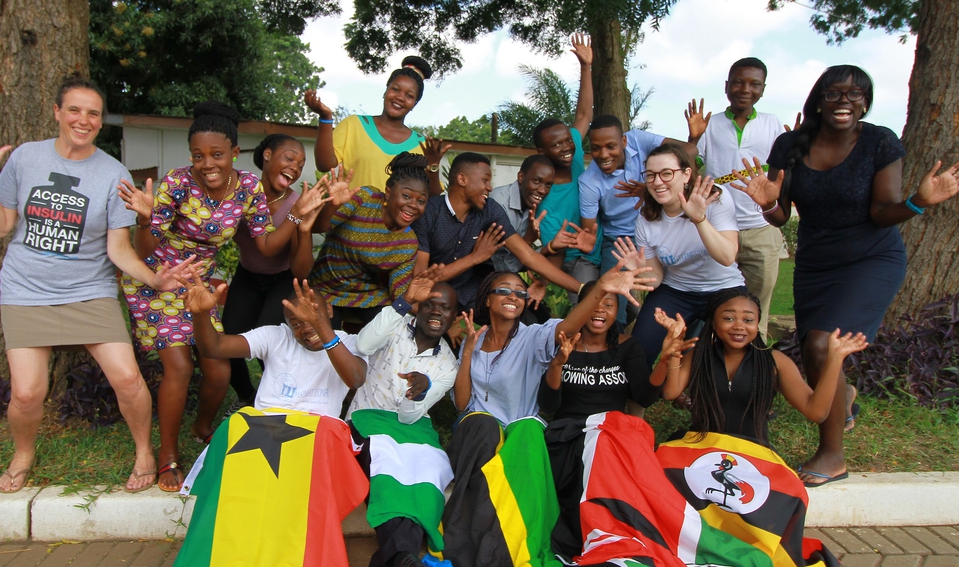 A group of African advocates with type 1 diabetes from Ghana, Uganda, Kenya, Nigeria and Tanzania stand smiling with their country flags